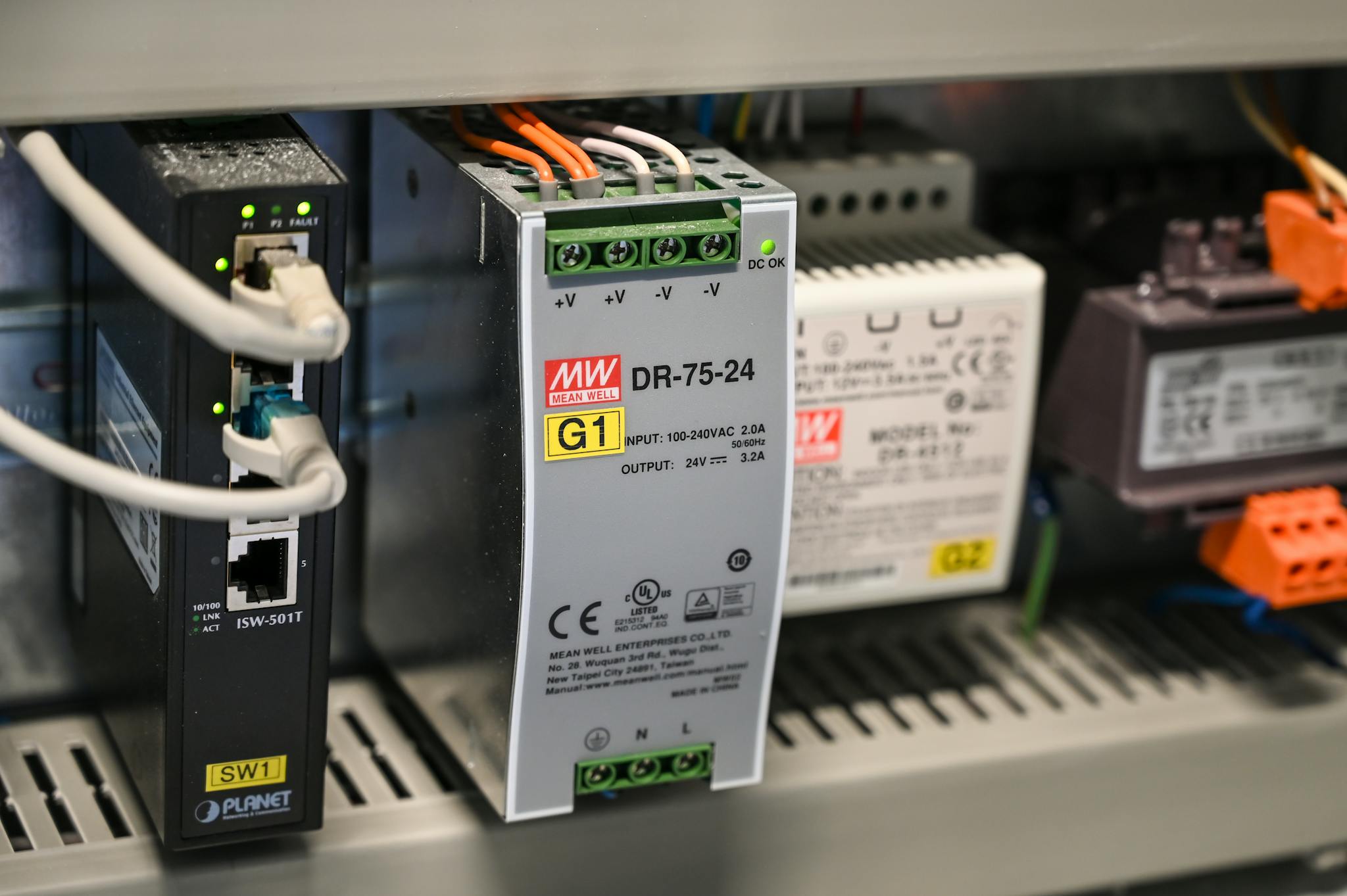 Close-up of electronic components and wires inside industrial equipment.